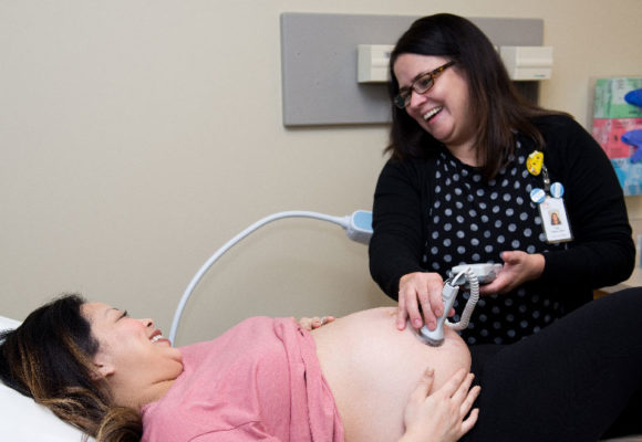 ultrasound technician with pregnant woman mother